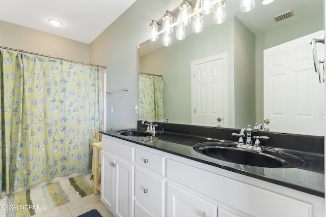 bathroom featuring tile patterned flooring and vanity