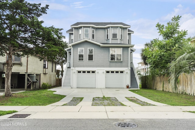 view of front of property featuring a garage and a front lawn