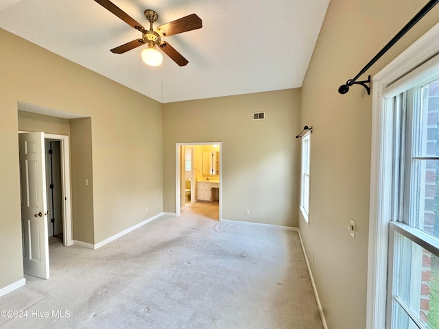 bonus room with plenty of natural light, light colored carpet, and vaulted ceiling