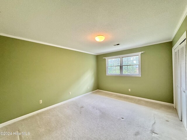 unfurnished bedroom with a textured ceiling and a closet