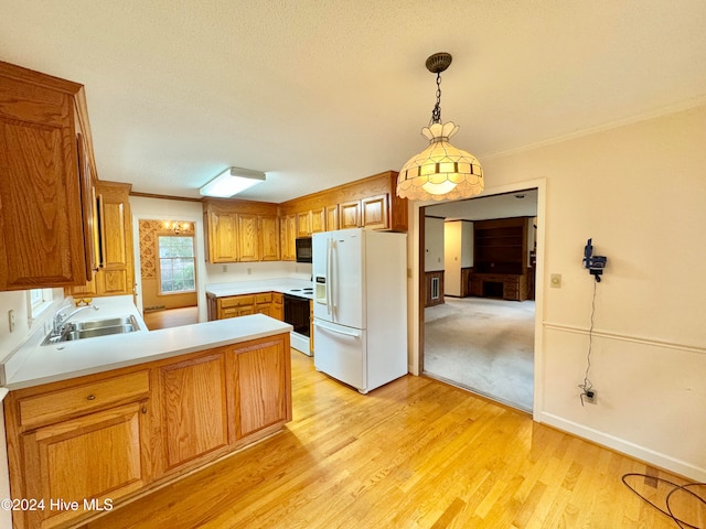 kitchen featuring light wood-type flooring, white appliances, a textured ceiling, and an inviting chandelier