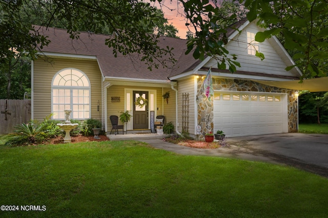 view of front of home featuring a yard and a garage