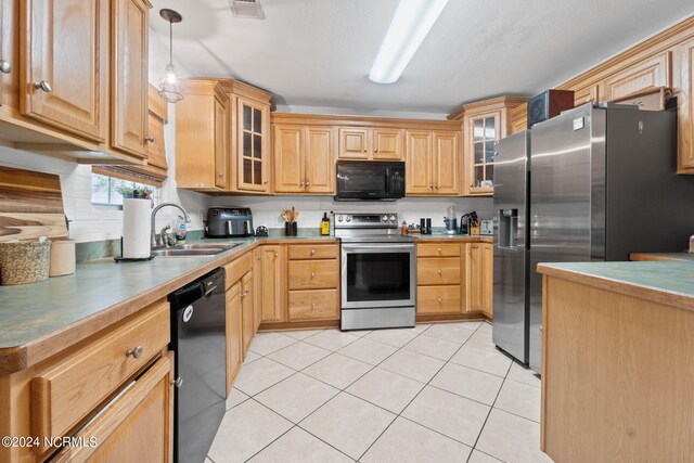 kitchen with light brown cabinets, light tile patterned floors, black appliances, decorative light fixtures, and sink