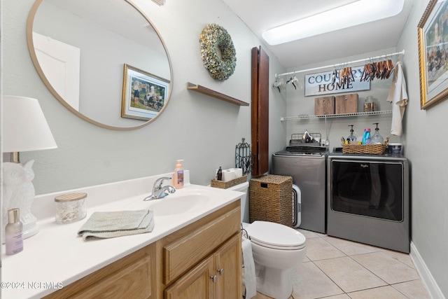 bathroom with vanity, washing machine and clothes dryer, tile patterned floors, and toilet