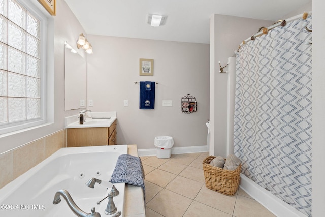 bathroom featuring tile patterned floors, independent shower and bath, vanity, and a wealth of natural light