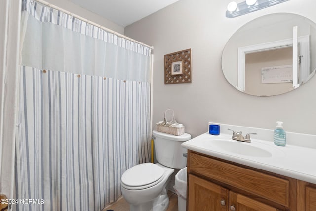 bathroom featuring vanity, toilet, and a shower with shower curtain