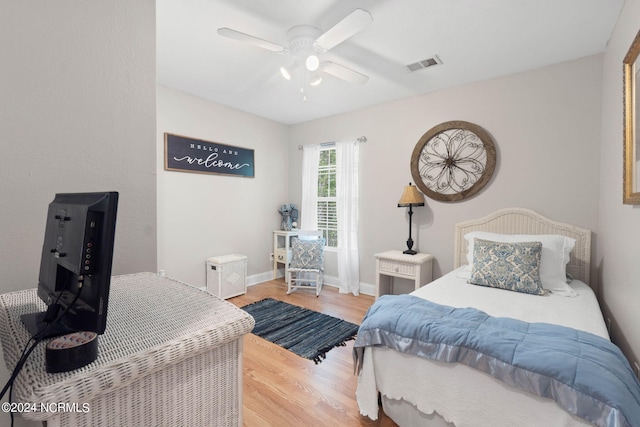 bedroom featuring hardwood / wood-style flooring and ceiling fan