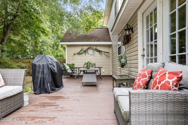 wooden deck featuring grilling area and an outdoor hangout area