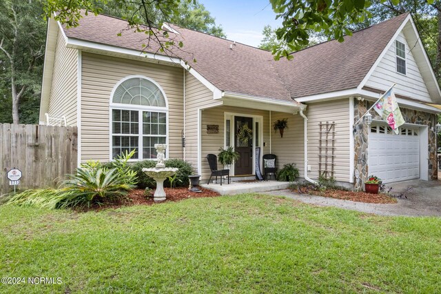 view of front of house featuring a garage and a front lawn