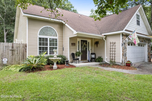 view of front of house with a garage and a front yard