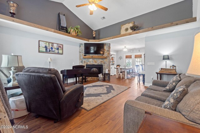 living room featuring ceiling fan, high vaulted ceiling, a fireplace, and hardwood / wood-style floors