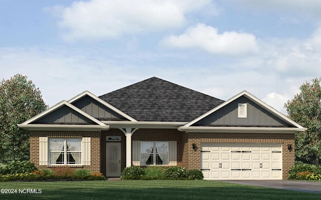 view of front of home featuring a garage and a front yard