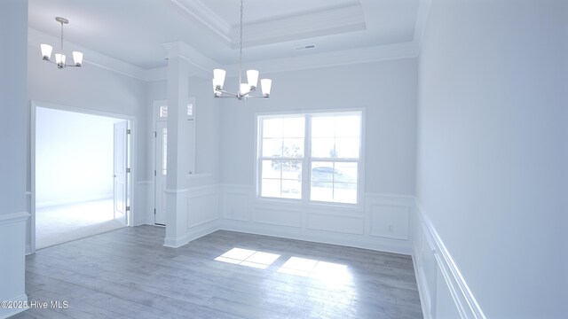 1219 St Simons Dr SE, Bolivia, NC 28422 - entryway featuring a chandelier, healthy amount of natural light, light wood-style flooring, crown molding, and wainscoting