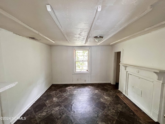 empty room featuring baseboards