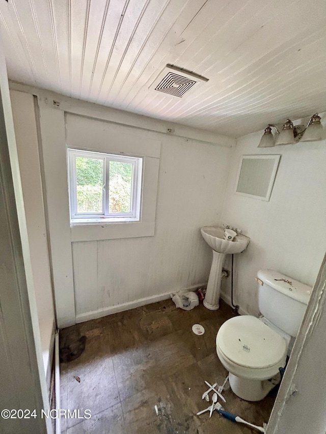 half bath with wooden ceiling, visible vents, and toilet