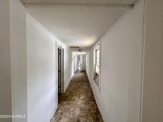 hallway with baseboards and visible vents