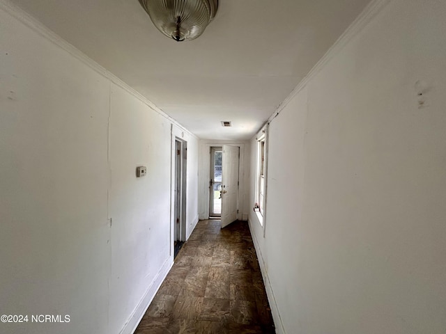 hall with baseboards and crown molding