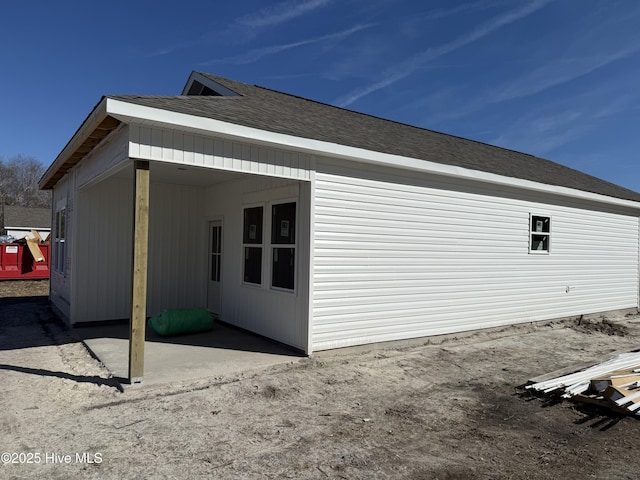 view of side of property with a patio