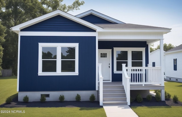 view of front of house featuring a porch, a front yard, and a shingled roof