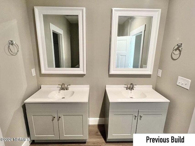 bathroom with vanity and hardwood / wood-style floors