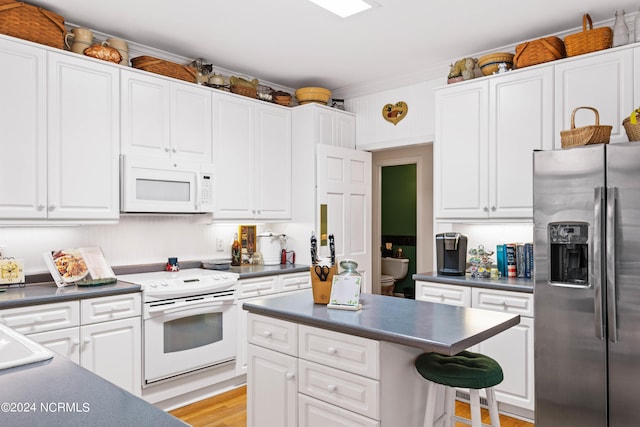 kitchen featuring white cabinetry and white appliances