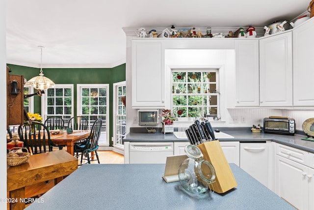 kitchen with white cabinetry, a healthy amount of sunlight, white dishwasher, and hanging light fixtures