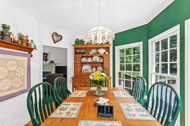 dining space featuring crown molding and a chandelier