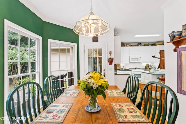 dining area featuring ornamental molding and a chandelier