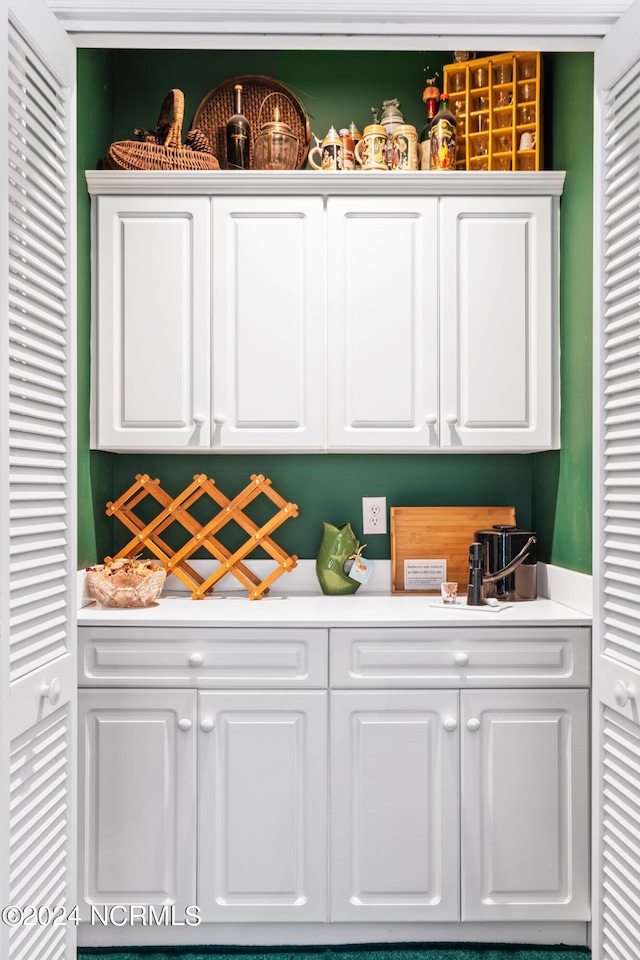 bar featuring white cabinetry