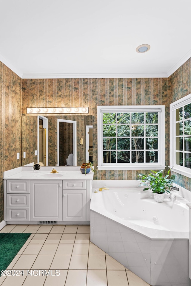 bathroom with tile patterned flooring, vanity, crown molding, and a bathing tub