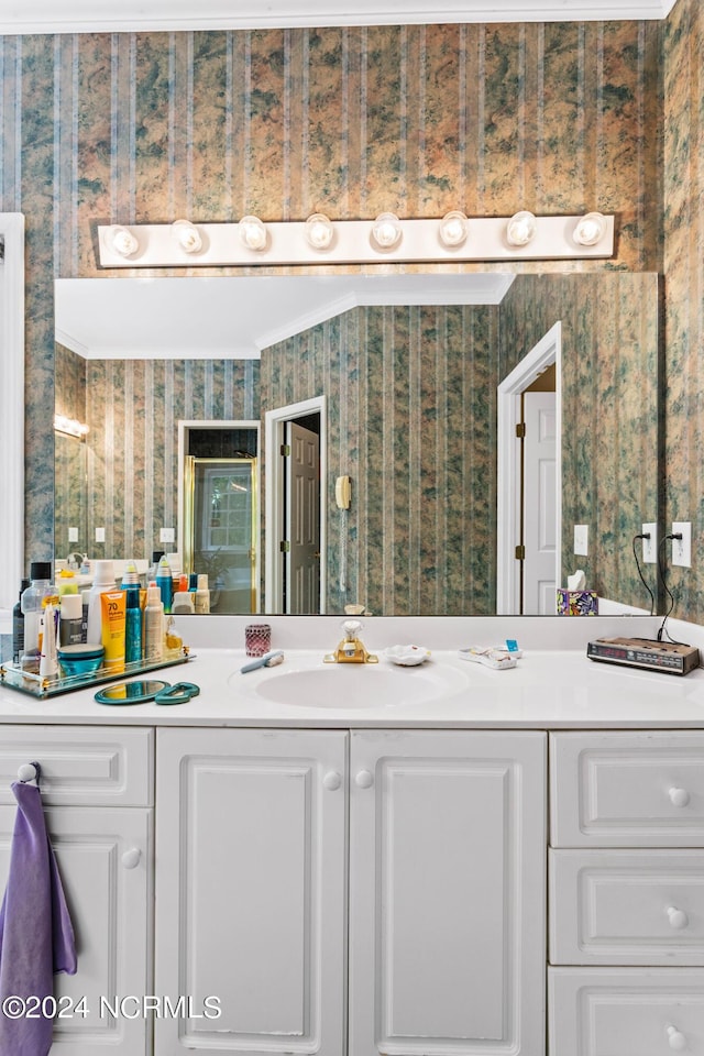 bathroom featuring ornamental molding and vanity