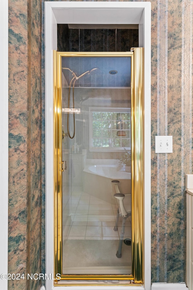 bathroom featuring tile patterned flooring and an enclosed shower