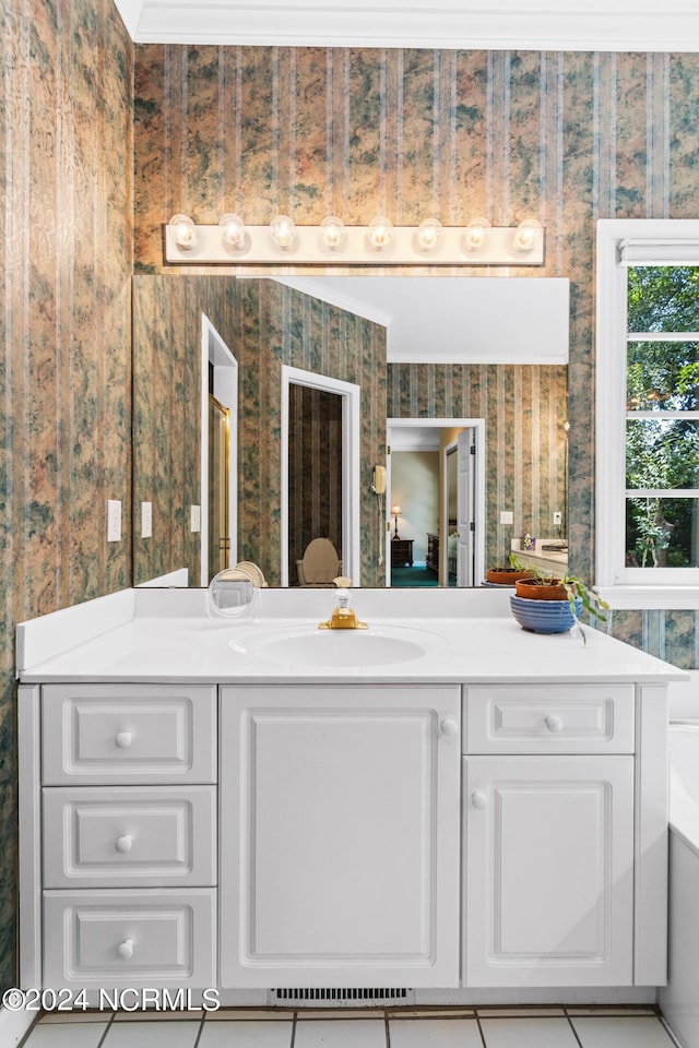 bathroom with tile patterned flooring, crown molding, and vanity