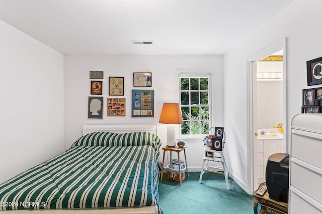 bedroom with carpet and connected bathroom