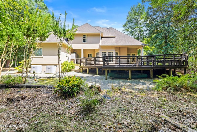 back of property with cooling unit and a wooden deck