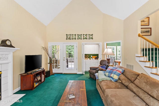 living room featuring dark colored carpet, a healthy amount of sunlight, high vaulted ceiling, and french doors