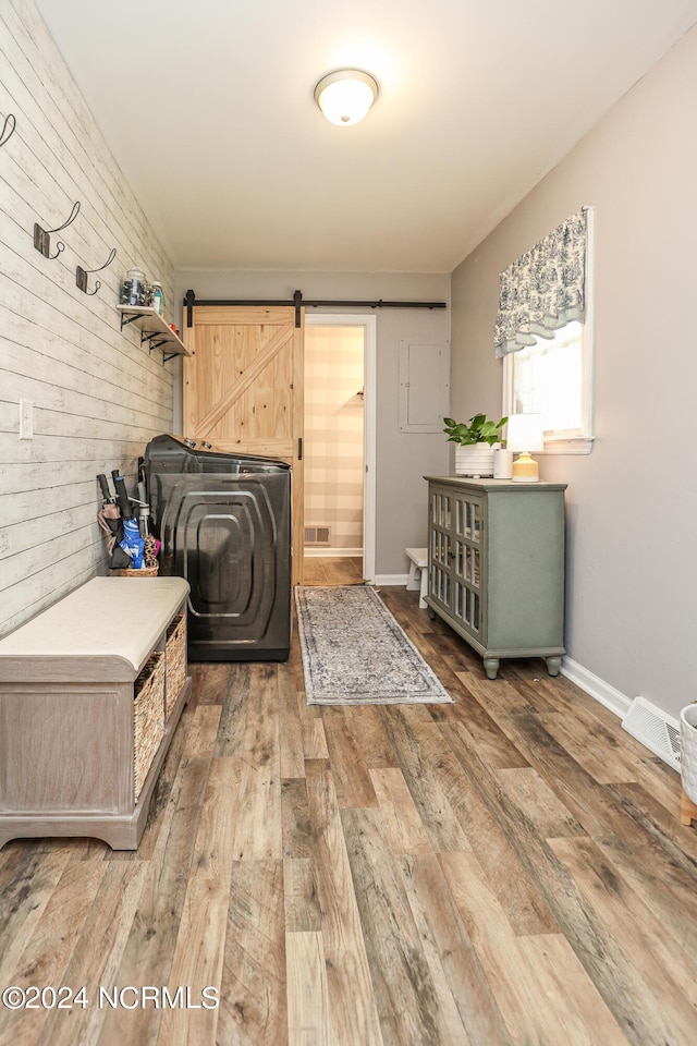 laundry room with cabinets, dark hardwood / wood-style floors, and wood walls