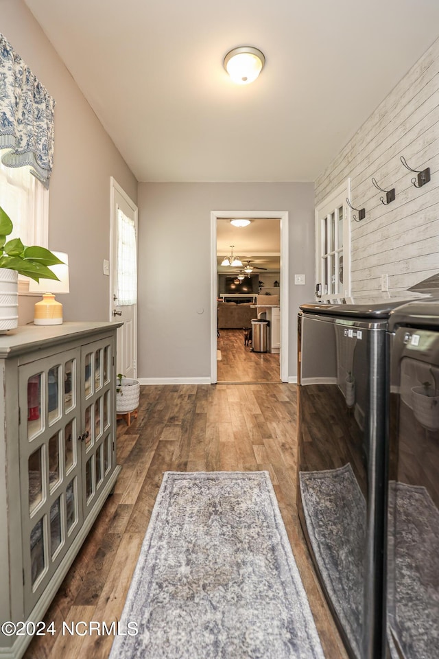 clothes washing area featuring dark hardwood / wood-style floors and washer and clothes dryer