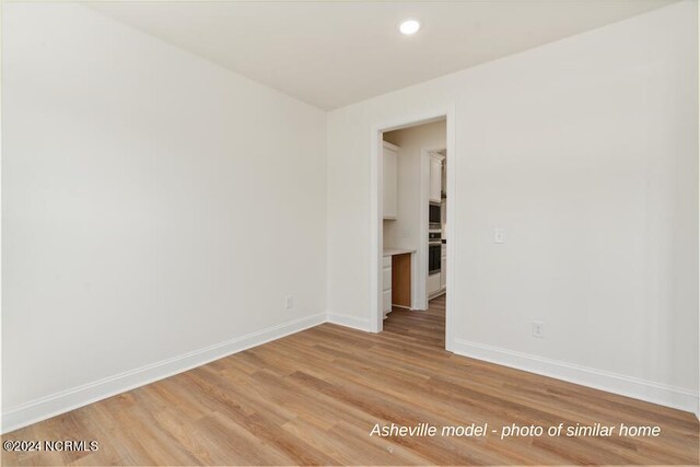 spare room featuring light hardwood / wood-style floors