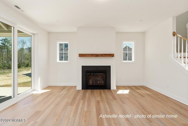 unfurnished living room with light hardwood / wood-style floors