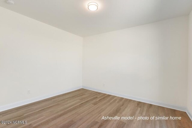 unfurnished room featuring hardwood / wood-style flooring