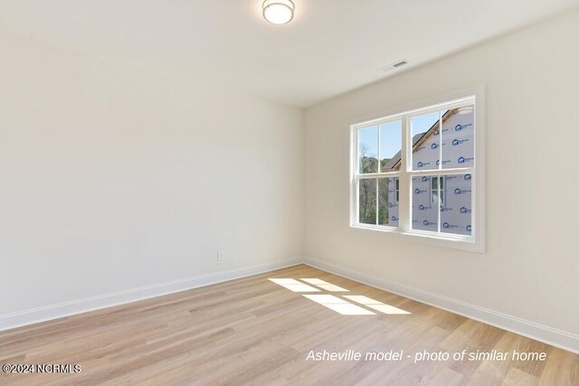 spare room with light hardwood / wood-style floors