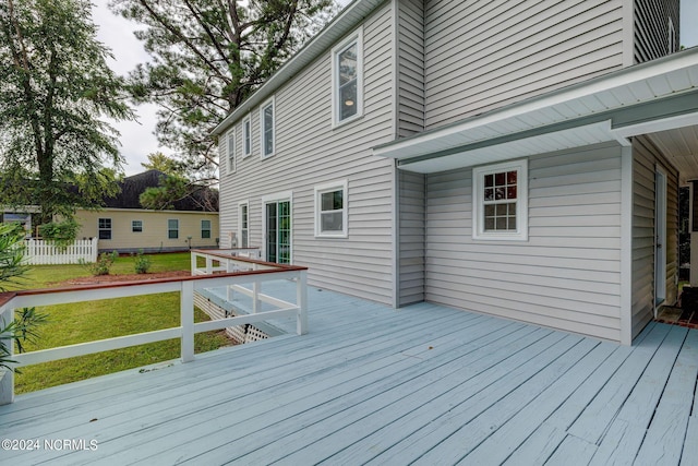 wooden deck with a lawn