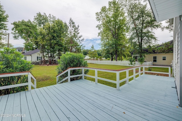 wooden deck featuring a yard