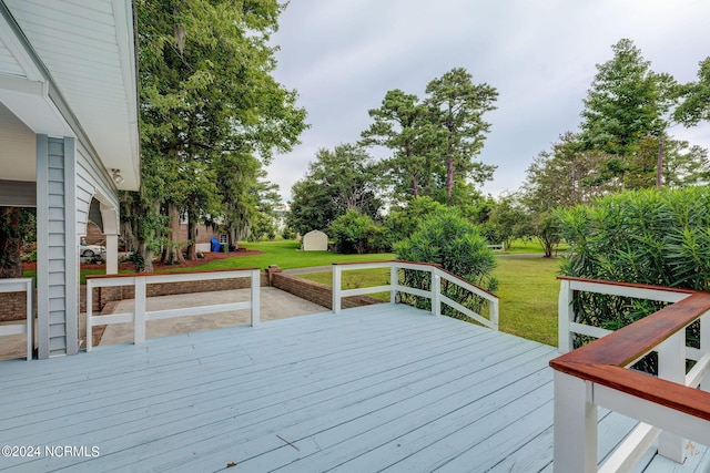 wooden deck with a lawn