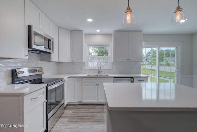 kitchen featuring sink, white cabinets, a healthy amount of sunlight, and appliances with stainless steel finishes