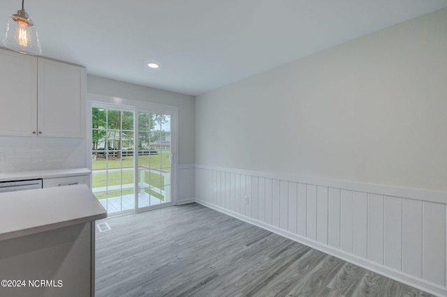 unfurnished dining area with light hardwood / wood-style floors