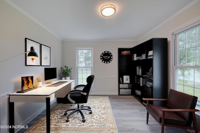 office area with plenty of natural light, light hardwood / wood-style floors, and ornamental molding