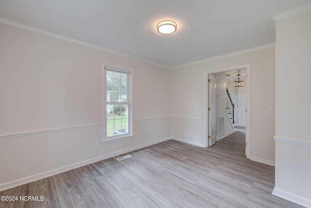 empty room featuring ornamental molding and light hardwood / wood-style flooring