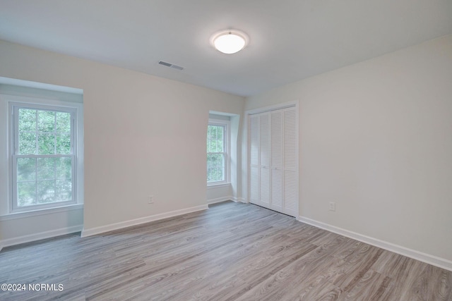 empty room featuring a healthy amount of sunlight and light wood-type flooring